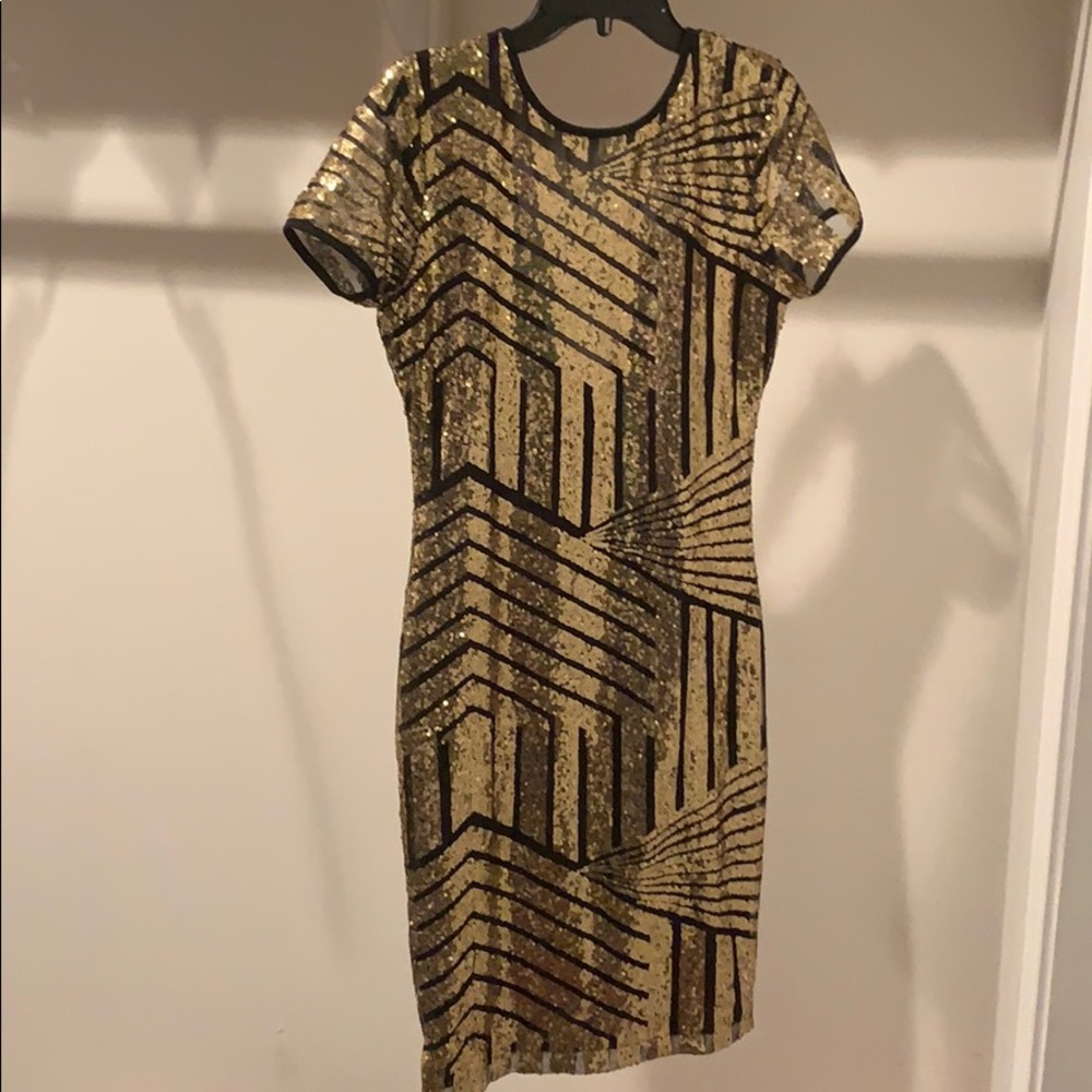 Gold sequined dress with black pattering.